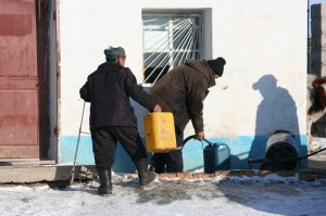 Jerrycans being filled at a water kiosk.